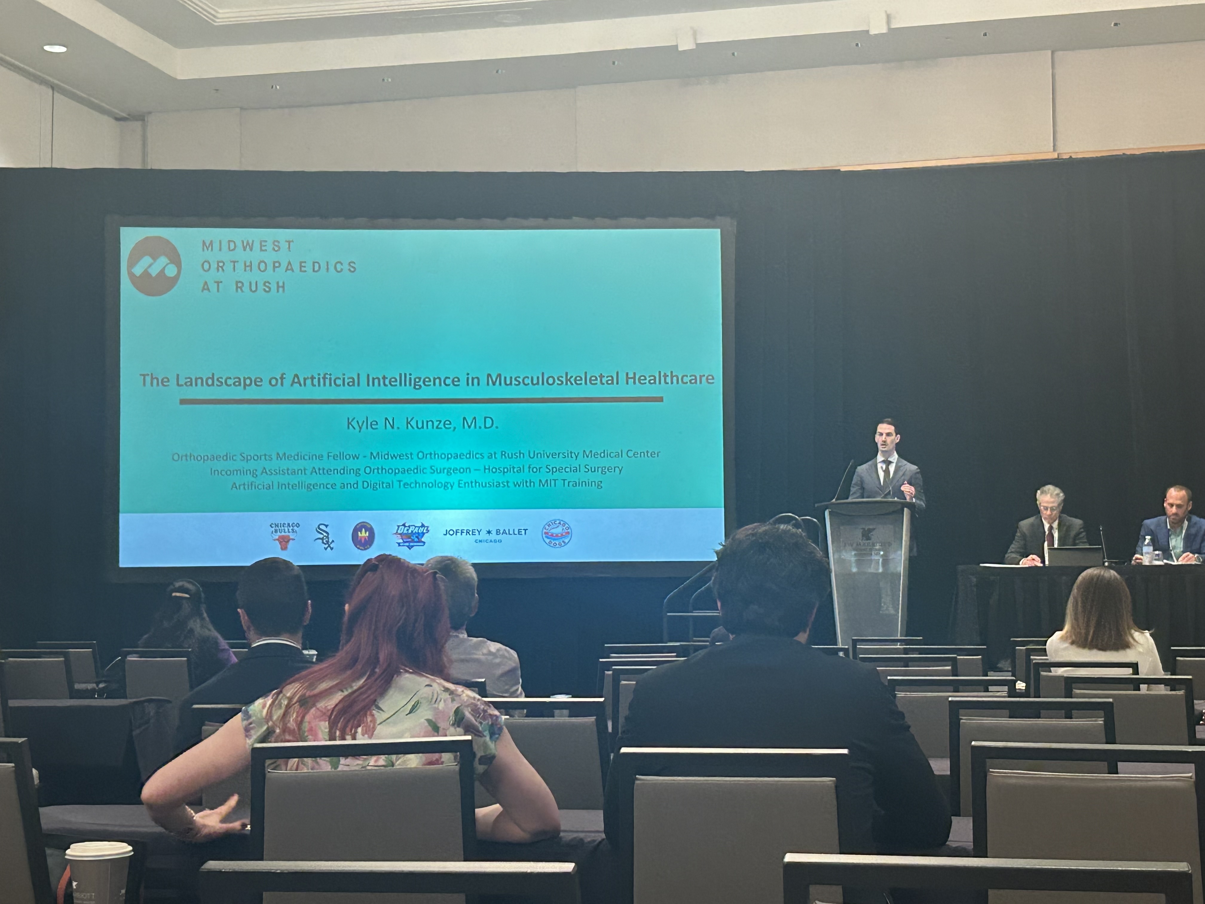 Dr. Kunze speaking on AI in orthopedics